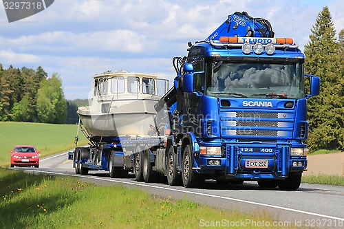 Image of Scania 124 Truck Hauls a Boat 