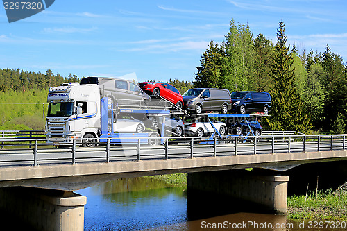 Image of Scania R480 Auto Carrier Hauls New Cars on Bridge