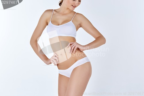 Image of Young, slim, healthy and beautiful woman in white lingerie 