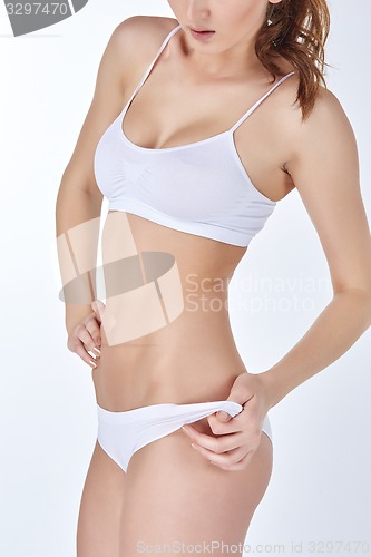 Image of Young, slim, healthy and beautiful woman in white lingerie 