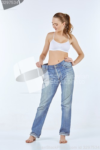 Image of Woman became skinny and wearing old jeans