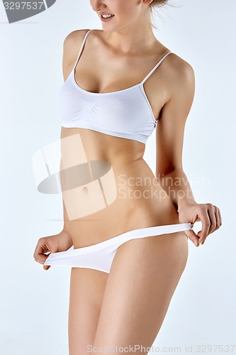 Image of Young, slim, healthy and beautiful woman in white lingerie 