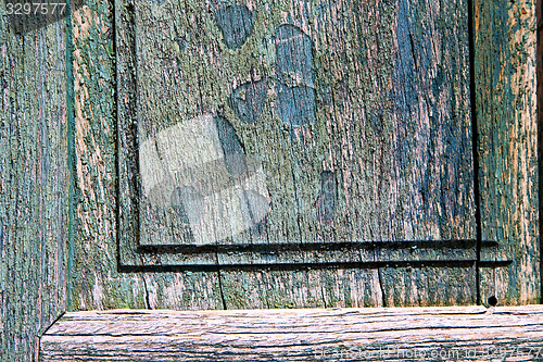 Image of  piece of wood brown knocker and wood  door cairate varese italy
