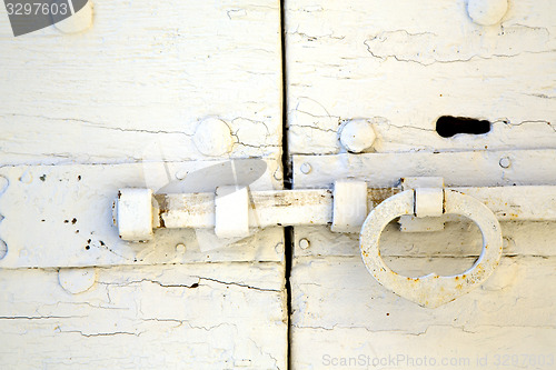 Image of white  tradate abstract   rusty brass brown knocker  