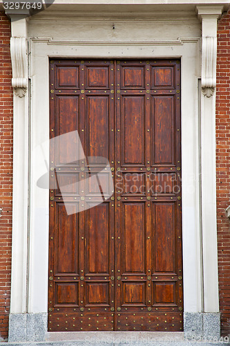 Image of  knocker and wood  door in a church crenna gallarate varese 