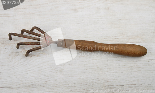 Image of Hand rake on wood