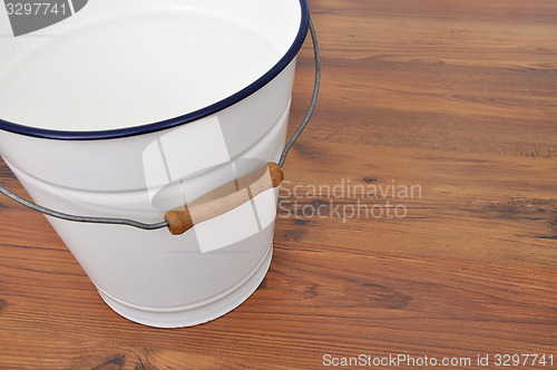 Image of Tin bucket on wood