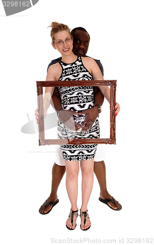 Image of Pregnant couple with picture frame.