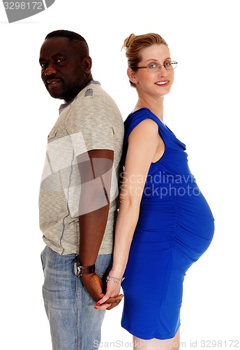 Image of Pregnant couple back to back.