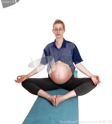 Image of Pregnant woman doing yoga.