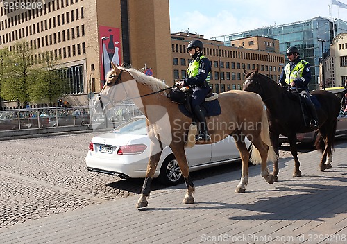 Image of HELSINKI, FINLAND – MAY 21, 2015: Mounted police patrol in the