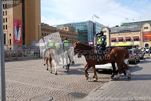 Image of HELSINKI, FINLAND – MAY 21, 2015: Mounted police patrol in the