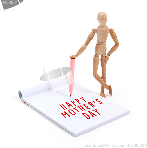 Image of Wooden mannequin writing in scrapbook - Happy mothers day