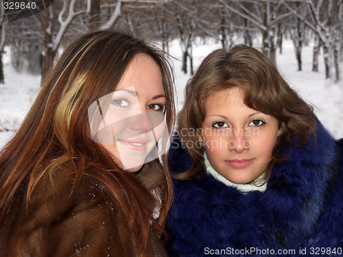 Image of Portrait of two girls in the winter in park