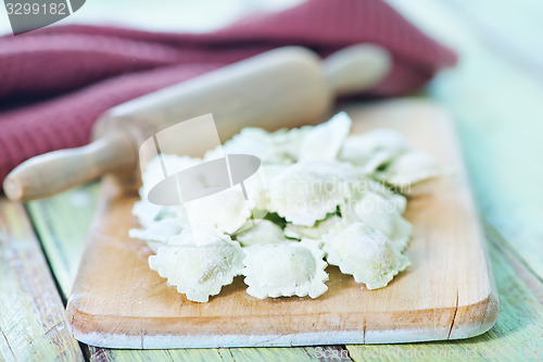 Image of flour and raw ravioli 