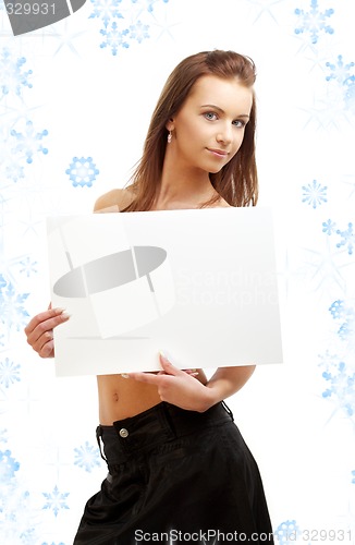 Image of girl holding blank sign board with snowflakes
