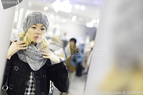 Image of Beautiful woman shopping in clothing store.