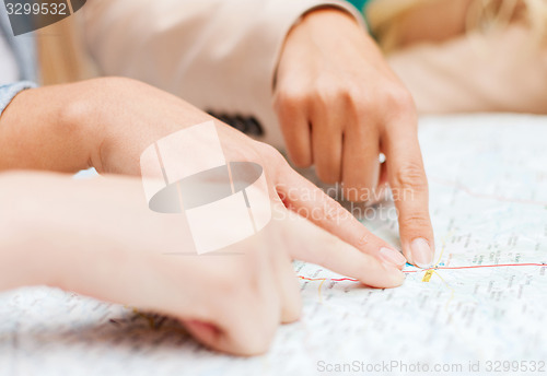 Image of friends with tourist map in the city