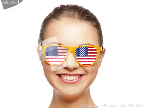 Image of happy teenage girl in shades with american flag