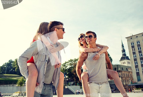 Image of smiling couple having fun in city