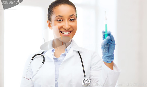 Image of african doctor holding syringe with injection