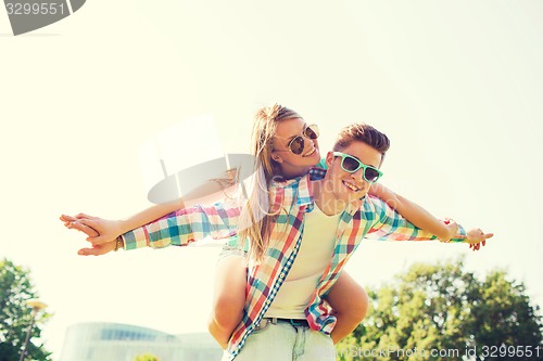 Image of smiling couple having fun in park