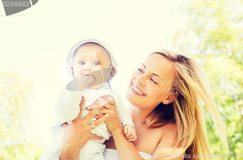 Image of happy mother with little baby outdoors