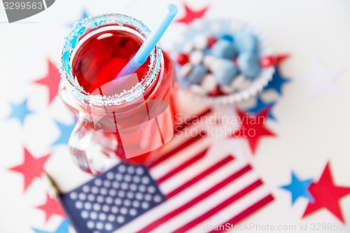 Image of juice glass and american flag on independence day