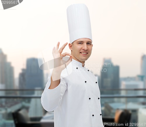 Image of happy male chef cook showing ok sign