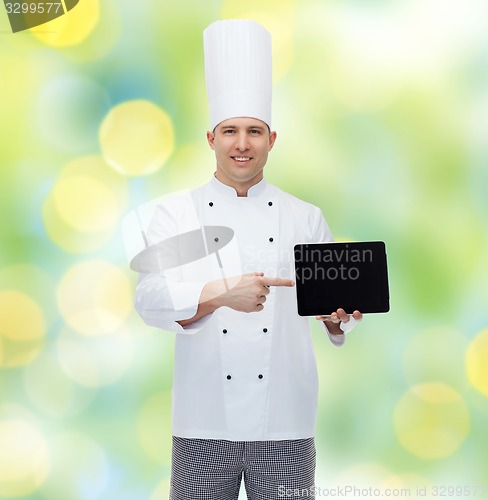 Image of happy male chef cook showing with tablet pc