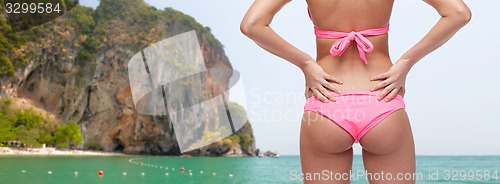 Image of close up of young woman buttocks in pink bikini