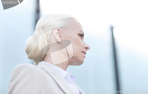 Image of young businesswoman over office building