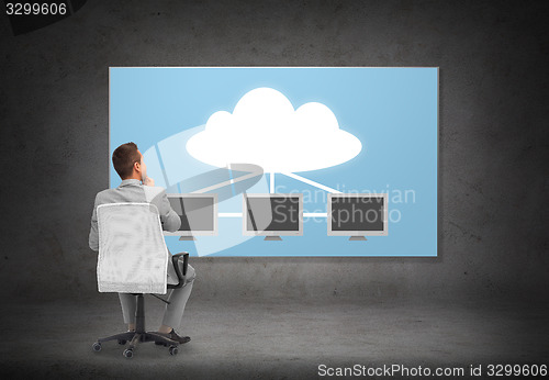 Image of businessman in office chair over cloud server