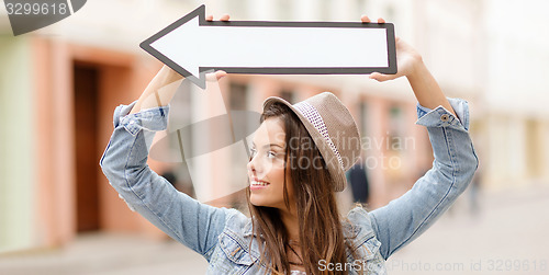 Image of girl showing direction with arrow in the city