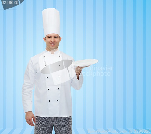 Image of happy male chef cook showing empty plate