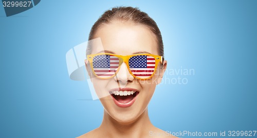 Image of happy teenage girl in shades with american flag