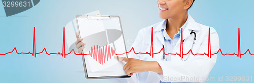Image of close up of smiling female doctor with clipboard