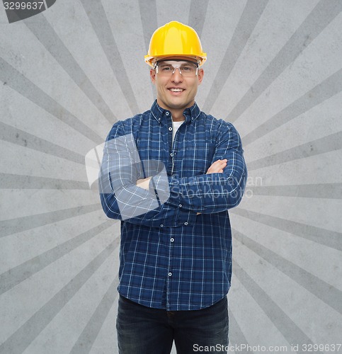 Image of smiling male builder or manual worker in helmet