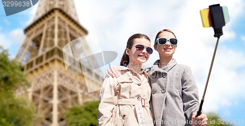 Image of girls with smartphone selfie stick at eiffel tower