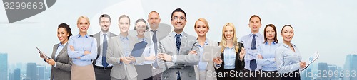Image of group of happy businesspeople over city background