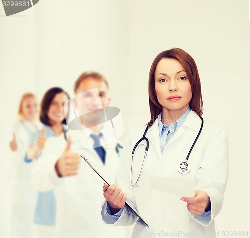 Image of calm female doctor with clipboard