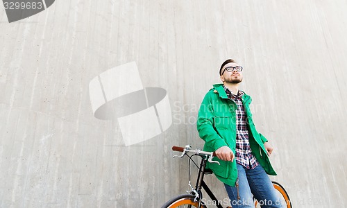 Image of happy young hipster man with fixed gear bike