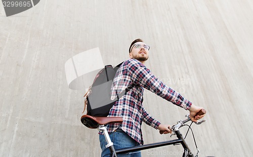 Image of hipster man with fixed gear bike and backpack