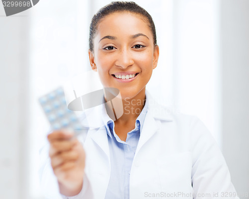 Image of doctor with blister packs of pills