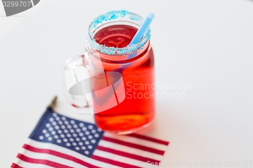 Image of juice glass and american flag on independence day