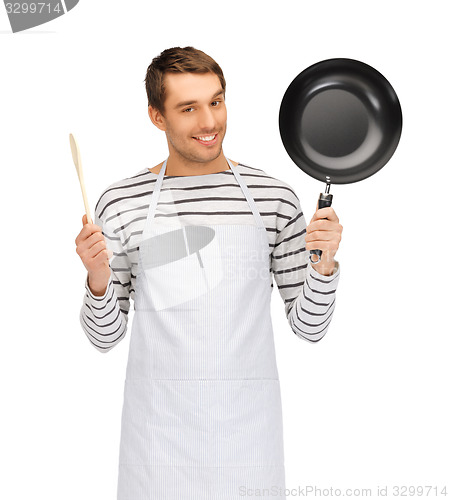 Image of happy man or cook in apron with pan and spoon