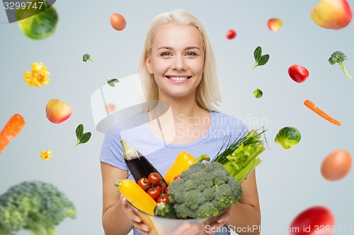 Image of smiling young woman with vegetables