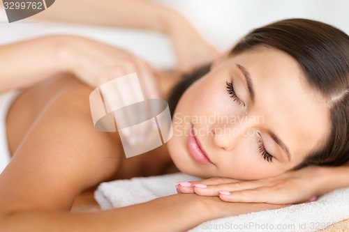 Image of beautiful woman in spa salon getting massage