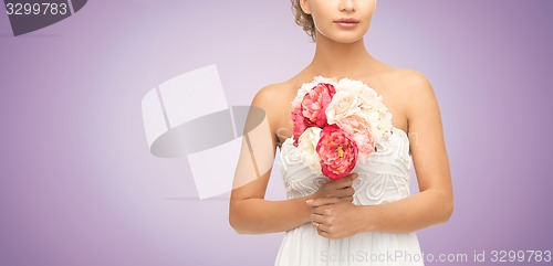 Image of bride or woman with bouquet of flowers