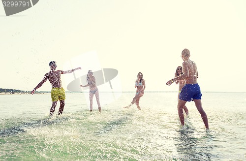 Image of happy friends having fun on summer beach